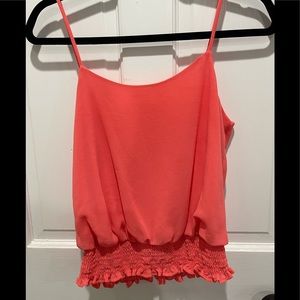 Adorable spaghetti strap blouse with cinched waist.